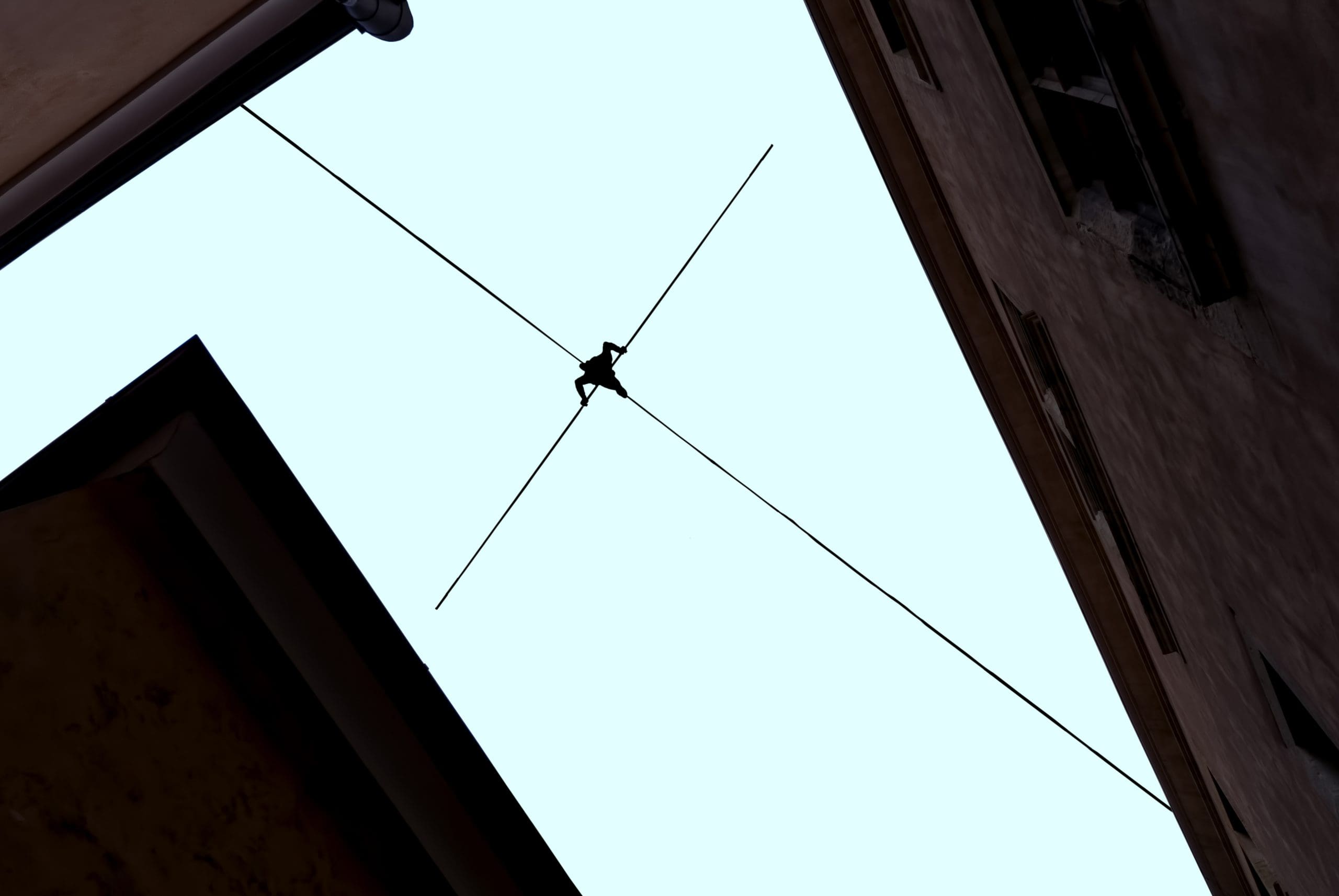 Highline walker balancing on the rope concept of risk taking and challenge
