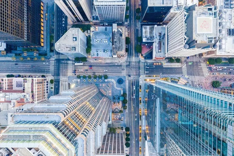 Aerial view of tall buildings and a busy downtown intersection.