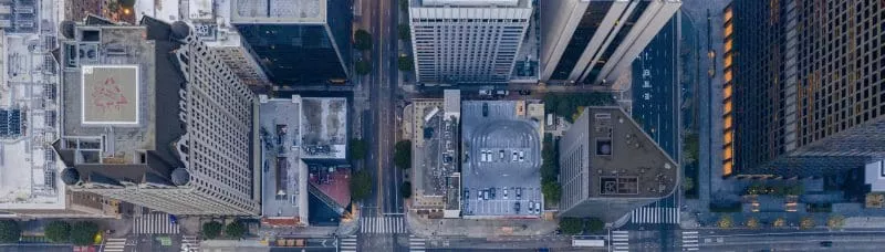 Aerial view of tall buildings and a busy downtown intersection.