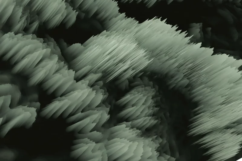 Abstract, swirling pattern of jagged, brush-like strokes in muted green tones, creating a textured, motion-filled appearance against a dark background.